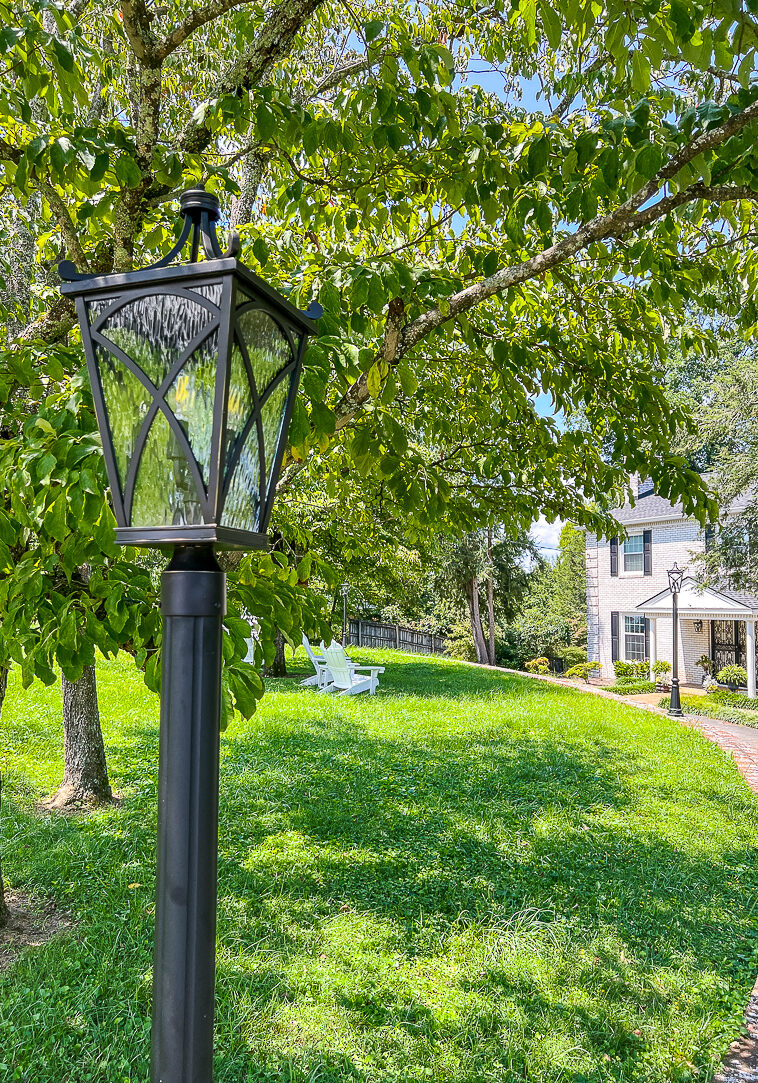 Upgraded outdoor lights with new lamp post lanterns and front door wall fixtures