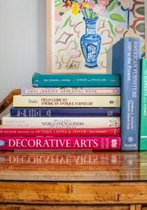 Stacks of resource books for collecting antiques