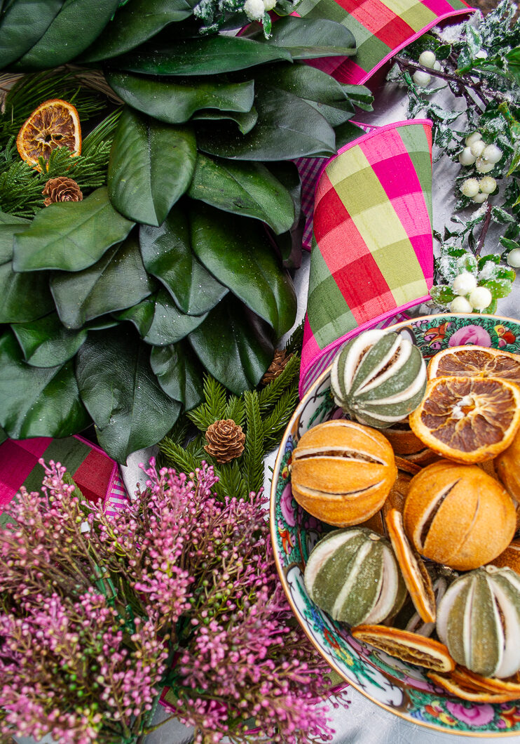 Floral and greenery materials for Williamsburg inspired magnolia & citrus Christmas wreath laid out on table