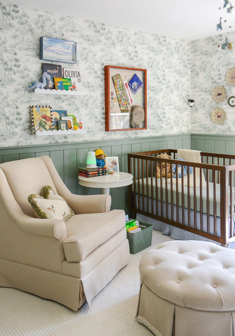 Tips for designing a nursery. Nursery rocker in green boy's nursery with woodland themed wallpaper and decor
